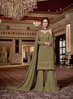 Here Is A Beautiful Shade To Add Into Your Wardrobe With This Designer Sharara Suit In Olive Green Color. This Pretty Sharara Suit Is Fabricated On Georgette Paired With Chiffon Fabricated Dupatta. Its Rich Color And Embroidery Will Earn You Lots Of Compliments From Onlookers. 