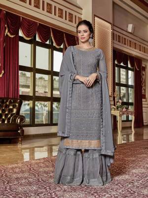 Flaunt Your Rich And Elegant Taste Wearing This Designer Sharara Suit In All Over Grey Color. Its Top And Bottom Are Georgette Based Beautified With Tone To Tone Embroidery And Jari work. This Sharara Suit Give A Subtle And Heavy Look Both At The Same Time. 