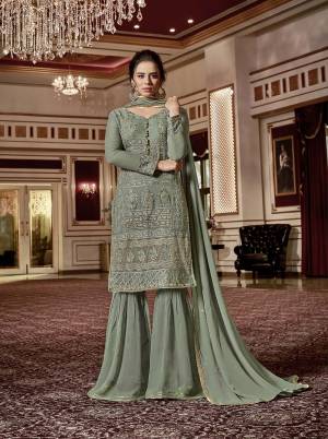 This Season Is About Subtle Shades And Pastel Play, So Grab This Very Beautiful And Heavy Designer Sharara Suit In Pastel Green Color. Its Top and Bottom are Fabricated On Georgette Paired With Chiffon Fabricated Dupatta. Buy Now.