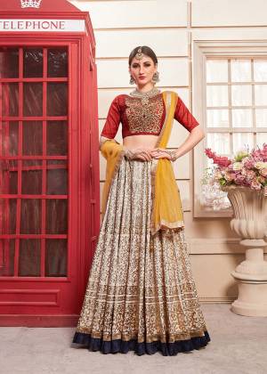 This Wedding Season Look The Most Amazing Of All Wearing This Heavy Designer Lehenga Choli In Red Colored Blouse Paired With Beige Colored Lehenga And Musturd Yellow Colored Dupatta. This Pretty Embroidered Lehenga Choli Is Fabricated On Art Silk Paired With Net Fabricated Dupatta. Buy Now.