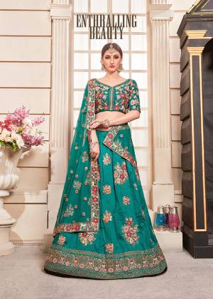 New Shade Is Here To Add Into Your Wardrobe With This Heavy Designer Lehenga Choli In All Over Teal Blue Color. Its Blouse And Lehenga Are Fabricated On Art Silk Paired With Net Fabricated Dupatta. It Is Beautified With Heavy Contrasting Embroidery Giving It An Attractive Look. 