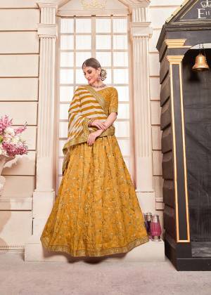 Shine Bright Wearing This Heavy Designer Lehenga Choli In Musturd Yellow Color Paired With Musturd Yellow And White Colored Dupatta. Its Blouse And Lehenga Are Fabricated On Art Silk Paired With Georgette Fabricated Dupatta. Its Fabrics Are Light Weight And Ensures Superb Comfort All Day Long. 