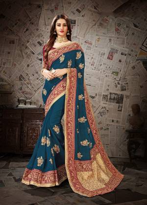 Pretty Attractive Color Pallete IS Here With This Heavy designer Saree In Blue Color Paired With Contrasting Maroon Colored Blouse .This Saree And Blouse Are Silk Based Beautified With Heavy Embroidery Work. Buy This Saree Now.