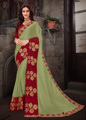 Simple And Elegant Looking Designer Saree Is Here In Light Green Color paired With Contrasting Red Colored Blouse .This Saree Is Fabricated On Georgette Paired With Art Silk Fabricated Blouse. Its Elegant Embroidery And Subtle Color Pallete Will Earn You Lots Of Compliments From Onlookers.