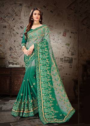 Here Is A Very Pretty Shaded Designer Saree To Add Into Your Wardrobe In Sea Green And Grey Color Paired With Sea Green Colored Blouse. This Heavy Embroidered Saree Is Fabricated on Chiffon Paired With art Silk Fabricated Blouse. Buy Now.