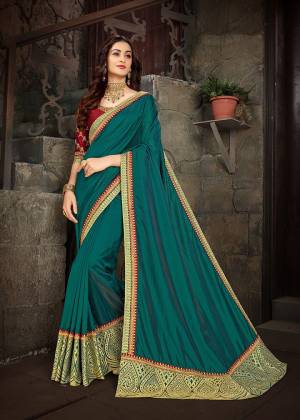 Pretty Attractive Color Pallete IS Here With This Heavy designer Saree In Teal Blue Color Paired With Contrasting Maroon Colored Blouse .This Saree Is Silk Based Beautified With Heavy Embroidery Work. Buy This Saree Now.