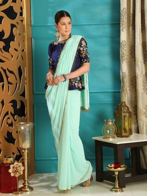 Enhance Your Personality In This Designer Saree With Peplum Patterned Blouse. This Georgette Based Saree Is In Aqua Blue Paired With Art Silk Fabricated Royal Blue Colored Blouse. Its Rich Color And Elegant Pattern Will earn You Lots Of Compliments From Onlookers. 