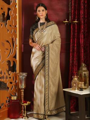 Flaunt Your Rich And Elegant Taste In This Royal Looking Designer Saree In Beige Color Paired With Black Colored Blouse. This Elegant Saree Is Silk Based Beautified With Embroidered Lace Border Paired With Velvet Fabricated Embroidered Blouse. 