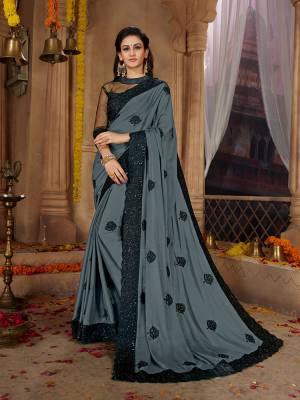 Here Is A Very Pretty Designer Based Saree In Grey Color Paired With Black Colored Blouse. This Pretty Saree Is Fabricated on Satin Georgette Paired With Art Silk And Net Fabricated Blouse. It Is Beautified With Black Colored Thread Work Motifs All Over. Also It Is Light In Weight And Easy To Carry Throughout The Gala. Buy Now