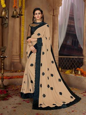 Here Is A Very Pretty Designer Based Saree In Beige Color Paired With Black Colored Blouse. This Pretty Saree Is Fabricated on Satin Georgette Paired With Art Silk And Net Fabricated Blouse. It Is Beautified With Black Colored Thread Work Motifs All Over. Also It Is Light In Weight And Easy To Carry Throughout The Gala. Buy Now