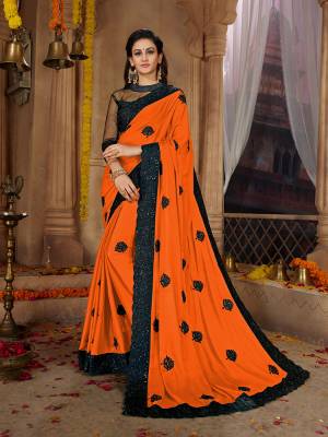 Here Is A Very Pretty Designer Based Saree In Orange Color Paired With Black Colored Blouse. This Pretty Saree Is Fabricated on Satin Georgette Paired With Art Silk And Net Fabricated Blouse. It Is Beautified With Black Colored Thread Work Motifs All Over. Also It Is Light In Weight And Easy To Carry Throughout The Gala. Buy Now