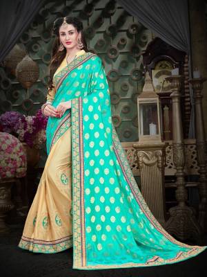 Celebrate This festive Season In This Designer Silk Based Saree In Aqua Green And Cream Color Paired With Cream Colored Blouse. This Saree Is Fabricated Jacquard And Art Silk Paired With Art Silk Fabricated Blouse. It Is Beautified With Jari And Thread Embroidery. 