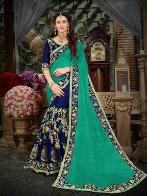 Get Ready For The Upcoming Festive And Wedding Season Wearing This Designer Saree In Sea Green And Navy Blue Color Paired With Navy Blue Colored Blouse. This Saree Is Fabricated On Georgette Paired With Art Silk Fabricated Blouse. Buy Now.