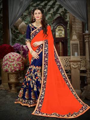 Get Ready For The Upcoming Festive And Wedding Season Wearing This Designer Saree In Orange And Navy Blue Color Paired With Navy Blue Colored Blouse. This Saree Is Fabricated On Georgette Paired With Art Silk Fabricated Blouse. Buy Now.