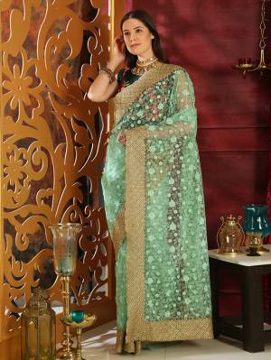 You Will Definitely Earn Lots Of Compliments Wearing This Designer Saree In Mint Green Color Paired With Teal Green Colored Blouse. This Heavy Embroidered Saree Is Fabricated On Orgenza Paired With Soft Silk Fabricated Blouse. This Saree Is Beautified With Jari Embroidery And Tone To Tone Thread Work Which Give A Heavy And Subtle Look Both At The Same Time. 