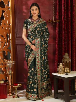 Enhance Your Personality In This Heavy Embroiderd Designer Saree In Dark Green Color. This Saree And Blouse Are Fabricated on Soft Silk Which IS Light Weight And Durable. Buy Now.
