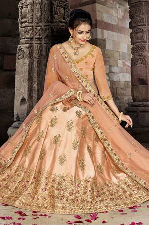 Grab This Very Beautiful And Elegant Looking Designer Lehenga Choli In All Over Light Orange Color. Its Blouse Is Fabricated On Art Silk Paired With Satin Silk Fabricated Lehenga And Net Fabricated Dupatta. It Is Beautified With Jari And Resham Embroidery With Stone Work. Buy Now.