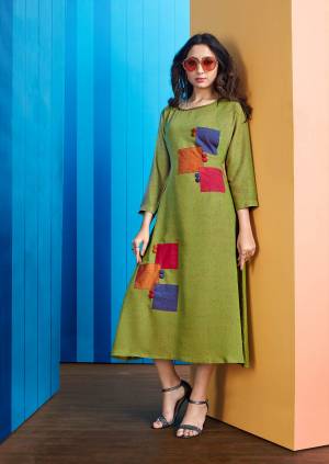 Here Is A Beautiful Patch Patterned Designer Readymade Kurti In Green Color Fabricated On Rayon Slub. It Has Multi Colored Patch Swatches With Buttons. 