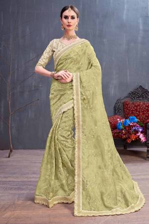 Get Ready For The Upcoming Festive And Wedding Season With This Heavy Designer Saree In Olive Green Color. This Pretty Saree Is Fabricated On Orgenza Paired With Art Silk Fabricated Blouse. It Is Beautified With Heavy Coding Embroidery With Sequence Work. Buy Now.