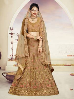 Grab This Very Beautiful And Elegant Looking Designer Lehenga Choli In All Over Light Brown Color. Its Blouse Is Fabricated On Art Silk Paired With Satin Silk Fabricated Lehenga And Net Fabricated Dupatta. It Is Beautified With Jari And Resham Embroidery With Stone Work. Buy Now.