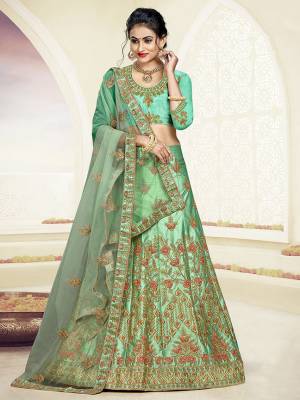 Grab This Very Beautiful And Elegant Looking Designer Lehenga Choli In All Over Sea Green Color. Its Blouse Is Fabricated On Art Silk Paired With Satin Silk Fabricated Lehenga And Net Fabricated Dupatta. It Is Beautified With Jari And Resham Embroidery With Stone Work. Buy Now.