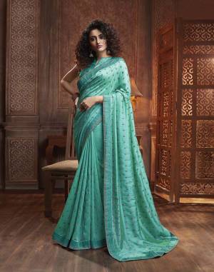 Celebrate This Festive Season With Beauty And Comfort Wearing This Designer Silk Based Saree In Turquoise Blue Color. This Saree Is Fabricated On Vichitra Silk Paired With Art Silk Fabricated Blouse. It Is Beautified With Itricate Embroidered Butti All Over. Buy This Lovely Saree Now.