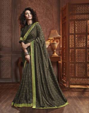 Celebrate This Festive Season With Beauty And Comfort Wearing This Designer Silk Based Saree In Dark Olive Green Color. This Saree Is Fabricated On Vichitra Silk Paired With Art Silk Fabricated Blouse. It Is Beautified With Itricate Embroidered Butti All Over. Buy This Lovely Saree Now.