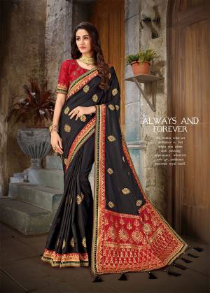 For A Bold And Beautiful Look In Traditionals, Grab This Designer Silk bAsed Saree In Black Color Paired With Red Colored Blouse. This Saree Has The Attractive Part Is Its Pallu Which Is Fabricated On Jacquard Silk. Buy Now.