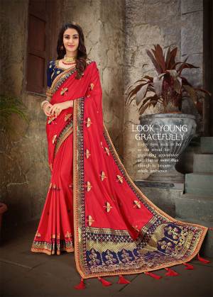Adorn The Pretty Angelic look In This Lovely Red Colored Designer Saree Paired With Contrasting Royal Blue Colored Blouse. This Saree And Blouse are Art Silk Beautified With Jacquard Silk Pallu And Embroidery. 