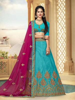 Look Beautiful Wearing This Heavy Designer Lehenga Choli In Blue Color Paired With Contrasting Magenta Pink Colored Dupatta. This Lehenga And Choli Are Fabricated On Art Silk Paired With Net Fabricated Dupatta. 