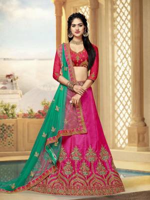 Look Beautiful Wearing This Heavy Designer Lehenga Choli In Dark Pink Color Paired With Contrasting Green Colored Dupatta. This Lehenga And Choli Are Fabricated On Art Silk Paired With Net Fabricated Dupatta. 