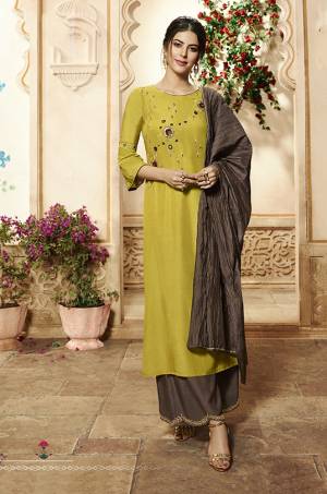New Shade Of Yellow And Green IS Here With This Readymade Suit In Pear Green Colored Top Paired With Brown Colored Bottom And Dupatta. Its Top Is Fabricated On Viscose Rayon Paired With Readymade Muslin Plazzo And Crush Muslin Dupatta. 