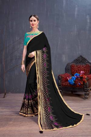 Add This Beautiful Designer Saree To Your Wardrobe In Black Color Paired With Sea Green Colored Blouse. This Saree Is Fabricated On Georgette Beautified With Rubber Foil Prints Paired With Art Silk Fabricated Embroiderded Blouse. 