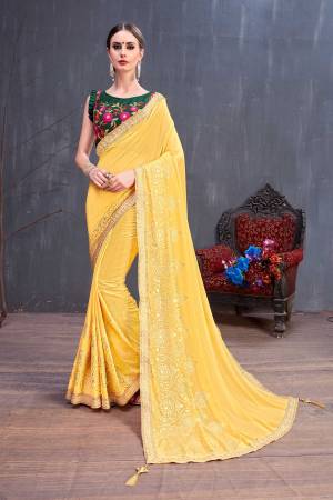 Celebrate This Festive Season With Beauty And Comfort Wearing This Designer Saree With Heavy Blouse Concept. This Pretty Saree Is In Yellow Color Paired With Contrasting Dark Green Colored Blouse. This Saree Is Fabricated On Georgette Paired With Embroidered Art Silk Blouse. It Is Light Weight , Easy To Carry And Durable. 