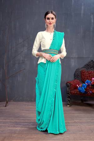 Here Is A Designer Saree With Indo-Western Look In Turquoise Blue Color Paired With Off-White Colored Blouse. This Saree Is Fabricated On Soft Cotton Paired With Art Silk Fabricated Blouse. Its Fabric Is Durable, Light Weight, Easy To Carry And Easy To Care For. Buy Now.