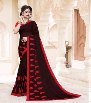 Grab This Very Pretty And Light Weight Designer Saree In Wine Color Paired With Contrasting Red Colored Blouse. This Saree Is Fabricated On Georgette Paired With Art Silk Fabricated Blouse. It Is Beautified With Thread Work Motif Giving An Attractive Look. 