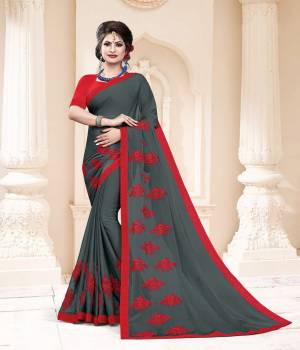 Grab This Very Pretty And Light Weight Designer Saree In Grey Color Paired With Contrasting Red Colored Blouse. This Saree Is Fabricated On Georgette Paired With Art Silk Fabricated Blouse. It Is Beautified With Thread Work Motif Giving An Attractive Look. 
