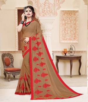 Grab This Very Pretty And Light Weight Designer Saree In Beige Color Paired With Contrasting Red Colored Blouse. This Saree Is Fabricated On Georgette Paired With Art Silk Fabricated Blouse. It Is Beautified With Thread Work Motif Giving An Attractive Look. 