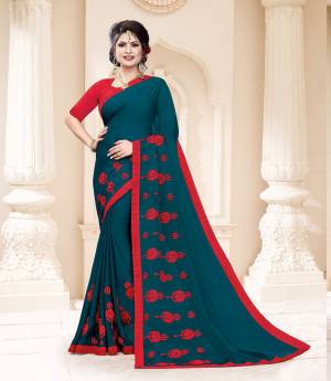 Grab This Very Pretty And Light Weight Designer Saree In Teal Blue Color Paired With Contrasting Red Colored Blouse. This Saree Is Fabricated On Georgette Paired With Art Silk Fabricated Blouse. It Is Beautified With Thread Work Motif Giving An Attractive Look. 