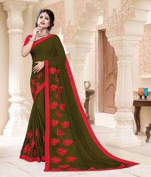 Grab This Very Pretty And Light Weight Designer Saree In Olive Green Color Paired With Contrasting Red Colored Blouse. This Saree Is Fabricated On Georgette Paired With Art Silk Fabricated Blouse. It Is Beautified With Thread Work Motif Giving An Attractive Look. 