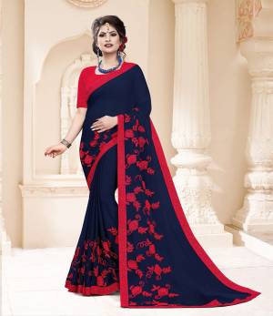 Grab This Very Pretty And Light Weight Designer Saree In Navy Blue Color Paired With Contrasting Red Colored Blouse. This Saree Is Fabricated On Georgette Paired With Art Silk Fabricated Blouse. It Is Beautified With Thread Work Motif Giving An Attractive Look. 