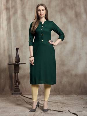 Simple And Elegant Readymade Plain Kurti Is Here In Dark Green Color For Your Casual Wear. This Kurti Is Fabricated On Rayon And Available In All Regular Sizes. It Is Suitable For College Wear, Home Or Work Place. 