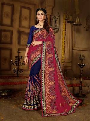 Get Ready For The Upcoming Wedding Season With This Heavy Designer Saree In Magenta Pink And Royal Blue Color Paired With Royal Blue Colored Blouse. This Saree And Blouse Are Silk based Which Gives A Rich And Elegant Look To Your Personality. 