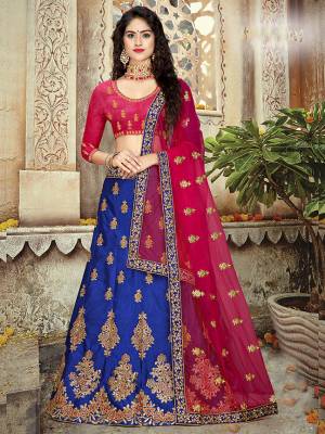 Bright And Visually Appealing Color Pallete Is Here With This Heavy Designer Lehenga Choli In Dark Pink Colored Blouse Paired With Contrasting Royal Blue Colored Lehenga And Dark Pink Colored Dupatta. 