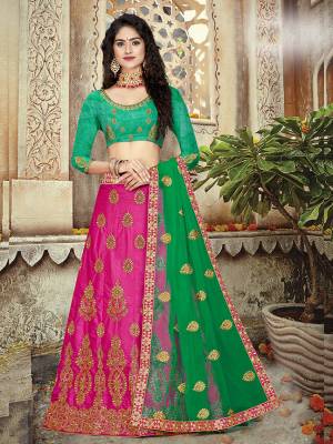 Add This Beautiful Designer Lehenga Choli To Your Wardobe In Green Colored Blouse Paired With Contrasting Rani Pink Colored Lehenga and Green Colored Dupatta. It Has Very Attractive Embroidery Which Gives An Enhanced Look To Your Personality. 