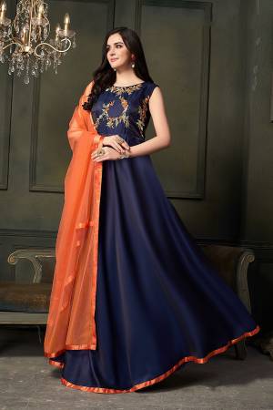 Enhance Your Personality Wearing This Heavy Designer Floor Length Suit In Navy Blue Color Paired With Contrasting Orange Colored Dupatta. Its Top Is Fabricated On Satin Silk Paired With Santoon Bottom And Net Fabricated Dupatta. 