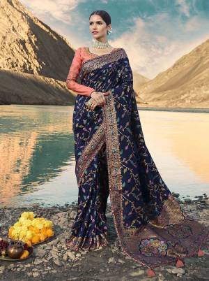Enhance Your Personality Wearing This Heavy Designer Saree In Navy Blue Paired Dark Peach Colored Blouse. This Saree Is Fabricated On Weaving Art Silk Paired With Art Silk Fabricated Blouse. It Is Beautified With Attractive Weave And Embroidery. Buy Now.