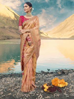 A Must Have Shade In Every Womens Wardrobe Is Here With This Designer Saree In Peach Color Paired With Contrasting Fuschia Pink Colored Blouse. This Saree And Blouse are Silk Based Beautified With Heavy Weave And Embroidery. Buy This Saree Now.