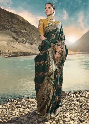Celebrate This Festive And Wedding Season With A Proper Ethnic Look Wearing This Designer Saree In Dark Green Color Paired With Contrasting Musturd Yellow Colored Blouse. This Saree Is Fabricated On Weaving Art Silk Paired With Art Silk Fabricated Blouse. Buy This Saree Now.