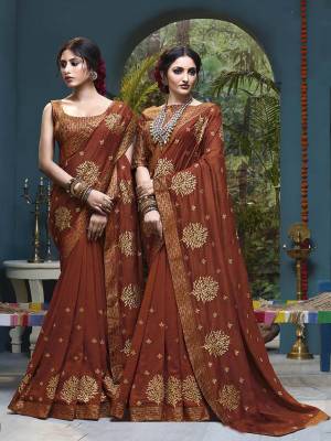 Grab This Beautiful Designer Silk Based Saree In Light Brown Color. This Pretty Saree Has Attractive Foil Prints Which Gives A Heavy Look To It. It Is Suitable For Festive As Well As Wedding Season. 